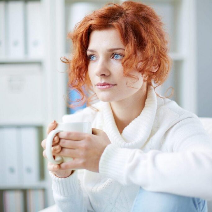 Anxious woman holding coffee