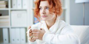 Anxious woman holding coffee